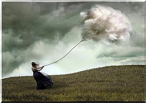 Woman holding on to rope with cloud