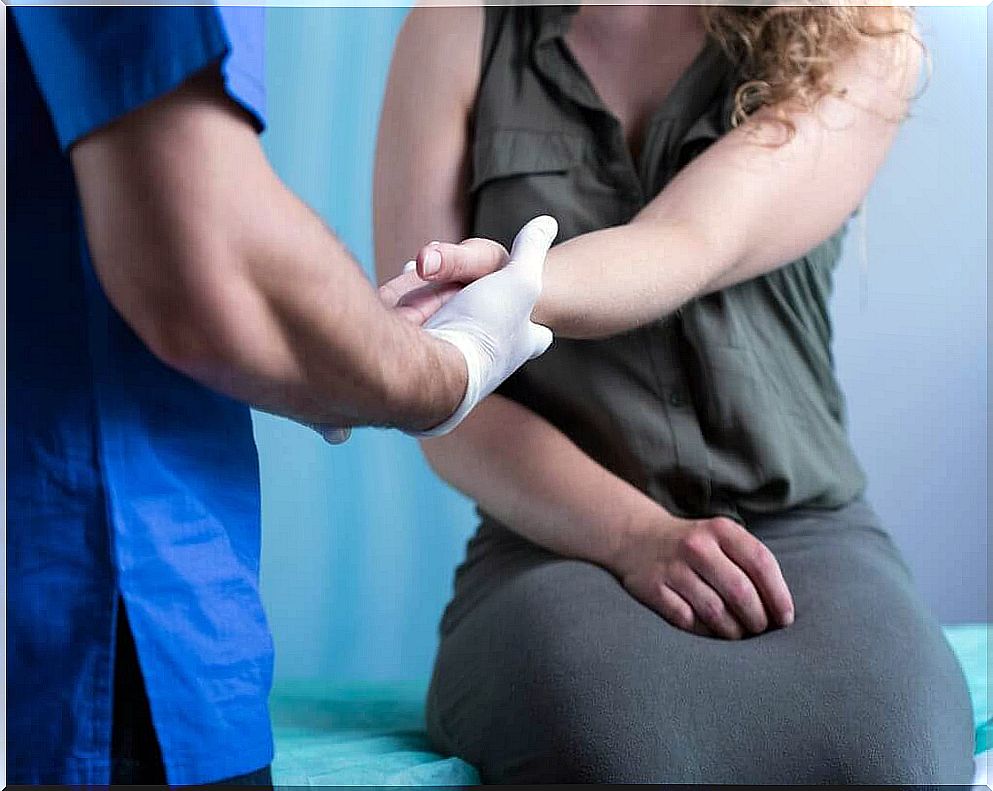 Doctor checks woman's hands