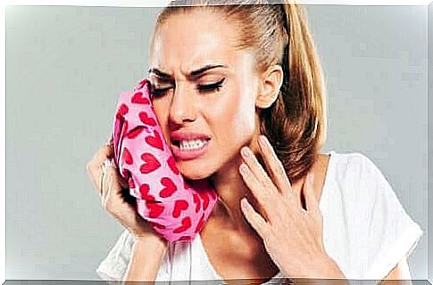 Woman relieving toothache with ice