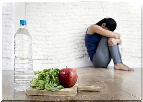 Depressed woman with water and food