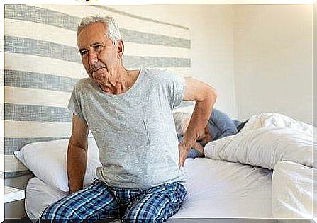 Man with joint pain sitting on the edge of the bed