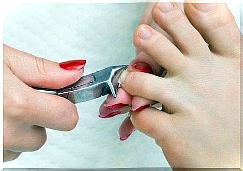 Woman cuts her toenails