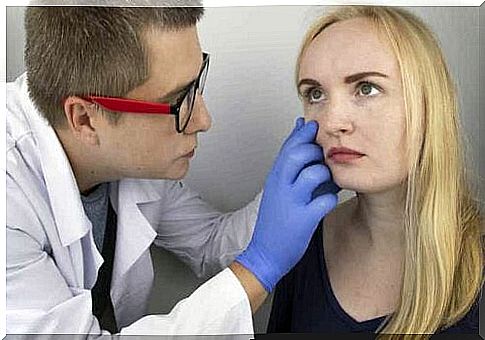 A doctor examining a woman's eyes