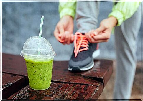 Woman drinking healthy drink before exercise