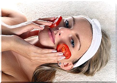 Woman with tomato slices on her face