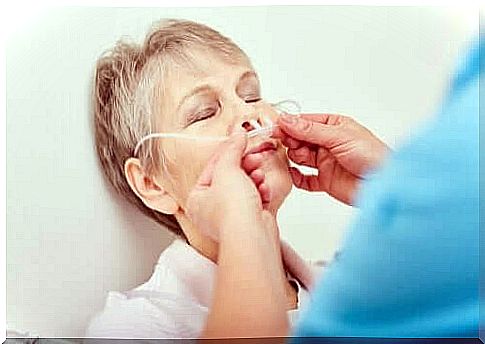 A doctor who adjusts a nasogastric tube.