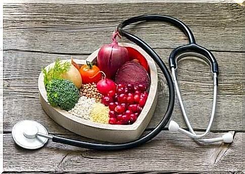 Fruit in a heart-shaped bowl and a stethoscope.